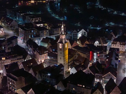Night view of a town with a dominant, illuminated church tower in the middle, Nagold, Calw