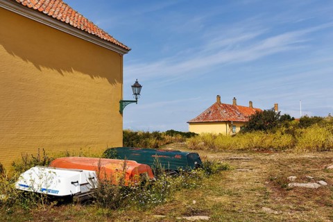 Rural coastal landscape, traditional buildings, state prison for political prisoners, three boats,