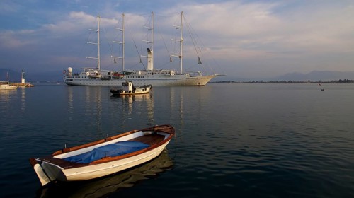 Nauplion harbour, sailing ship and small boat in harbour at sunset in calm water, Nauplion,