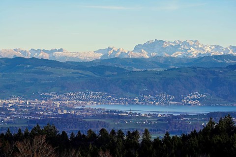 View from Horben of the city of Zug with Lake Zug, with the snow-covered Glarner Alps in the