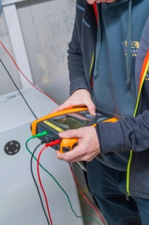 Technician checks a solar system with various cable connections