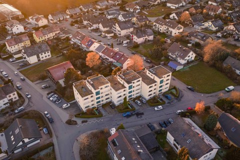 View of apartment buildings in a suburban neighborhood with parked cars, Althengstett, Calw