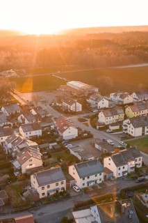 Suburb with houses and streets, illuminated by the evening sun, surrounded by nature, Althengstett,