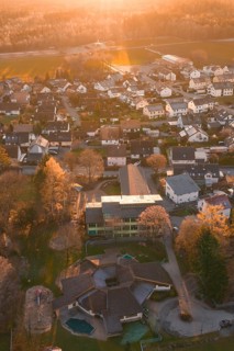View of residential area from the air with autumn trees and sunset atmosphere, Althengstett, Calw