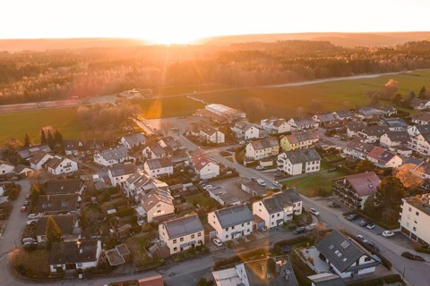 Aerial view of a suburb at sunset with numerous houses and roads, Althengstett, Calw district,