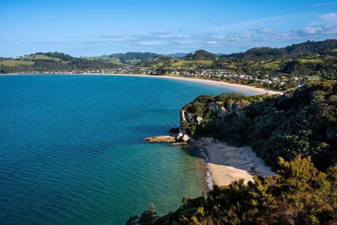 Landscape with sea and sandy beach in New Zealand. View of Lonely Bay and Cooks Beach from