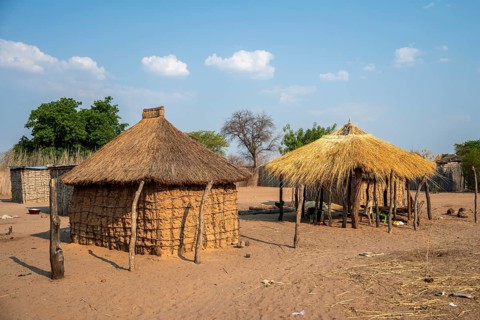 Locals in a typical village with clay huts, Caprivi Strip, Namibia