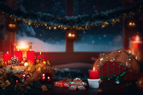 Winter scene with candles, gingerbread man, gifts and Christmas decoration