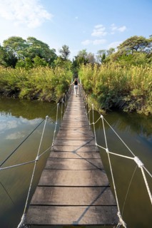 Toruist on the Kavango River, suspension bridge at Camp Kwando, Zambezi region, Caprivi Strip,