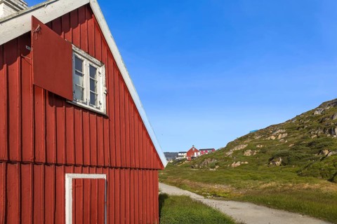 Typical architecture of Greenland Ilulissat with colored houses located near fjords and icebergs
