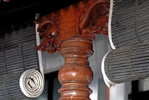 Close-up view of rolled bamboo blinds and artfully turned wooden post, Heritage Hotel Privacy,