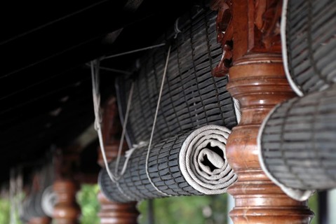 Close-up view of rolled bamboo blinds and artfully turned wooden posts, Heritage Hotel Privacy,