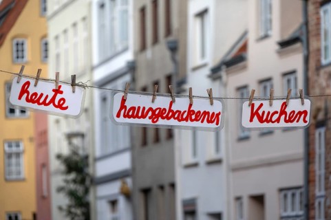 Home-baked cake today, signs on a clothesline across the street, Hanseatic City of LÃ¼beck,