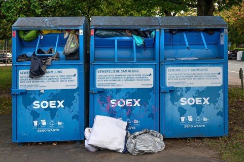 Overcrowded clothing containers in a parking lot, Hanseatic City of LÃ¼beck, Schleswig-Holstein,