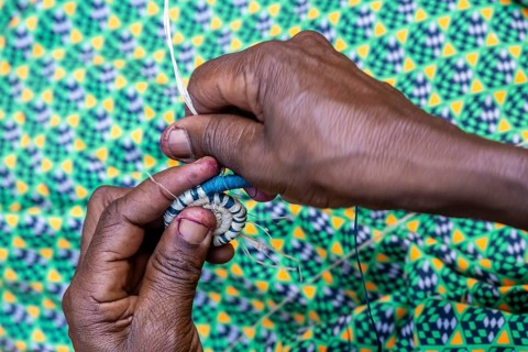 Local woman weaving baskets from papyrus, near Fort Portal, Uganda