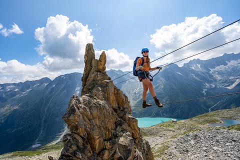 Crocodile rock formation, mountaineer on rope bridge in the Crocodile Mountain Lake via ferrata on