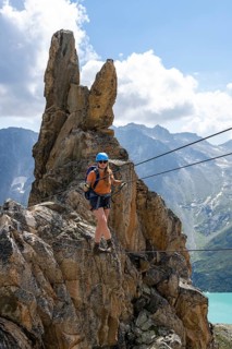 Crocodile rock formation, mountaineer on rope bridge in the Crocodile Mountain Lake via ferrata on
