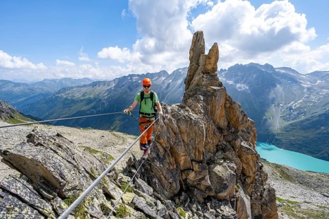 Crocodile rock formation, mountaineer on rope bridge in the Crocodile Mountain Lake via ferrata on
