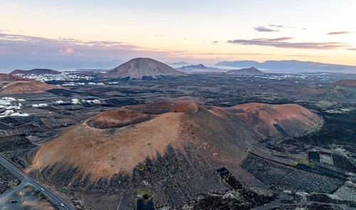Picturesque volcanic landscape with volcanic craters MontaÃ±a de la Tabaiba at sunrise, Parque
