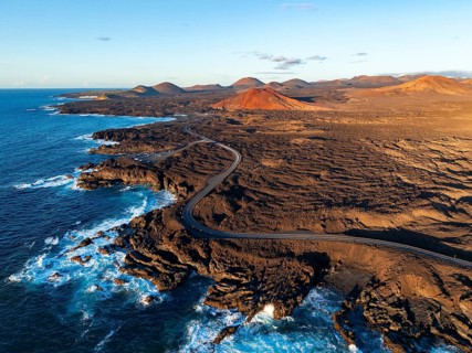 Coast with lava fields, volcanic landscape near Los Hervideros, in the evening light, aerial view,