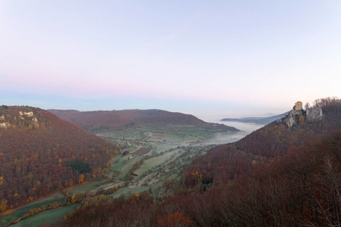 Sunrise with fog in the Neidlinger Valley with a view of the Reussenstein castle ruins. Swabian