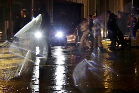 Passers-by in the evening in rainy weather in a city, November, Germany