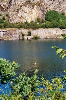 Tourist on a zip line across the lake, Opal Lake in the granite quarry, MoselleÃ¸kken