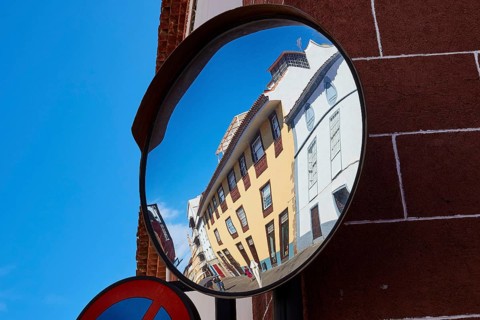 Architecture reflected distorted in a convex street mirror, UNESCO World Heritage Old Town of San