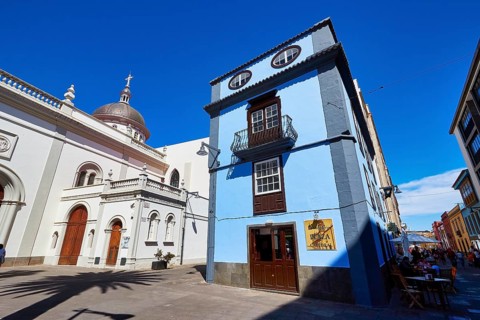 Blue building next to a historic domed church in the shadow of another building, UNESCO World