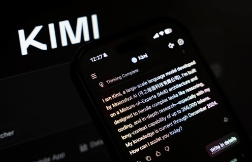 In this photo illustration, a person uses the Kimi AI chatbot on a smartphone while the KIMI logo
