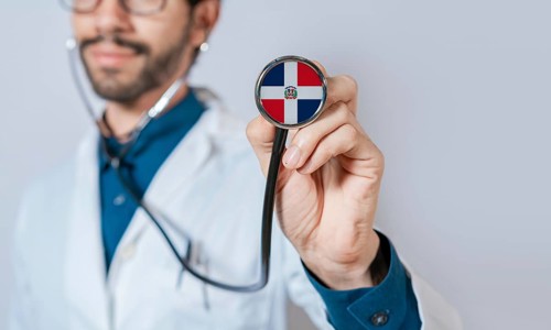 Doctor holding stethoscope with Dominican Republic flag. Dominican Republic health and care concept