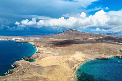 Headland and blue sea, coastal landscape, arid landscape of Los Ajaches Natural Park, aerial view,