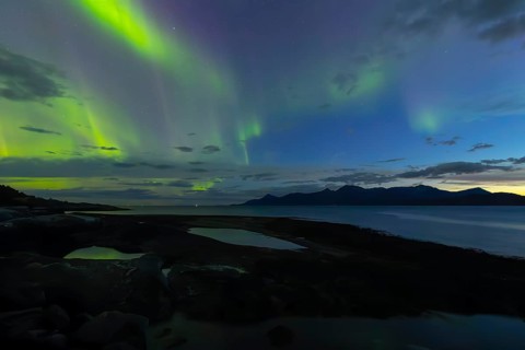 Northern lights at dawn over SÃ¸rfolda Fjord near KjerringÃ¸y between BodÃ¸ and SÃ¸rfold in Norway