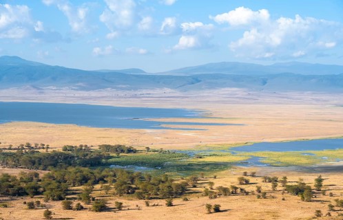 View of savanna landscape and lakes in the Ngorongoro Crater from the crater rim in the evening