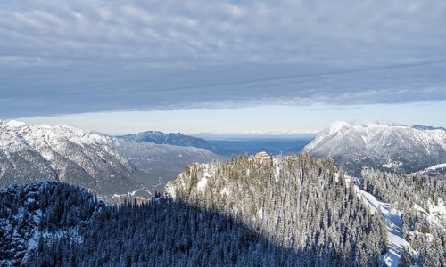 Snowy forest and Kreuzeckhaus mountain hut in the Garmisch Classic ski area in winter, Wetterstein
