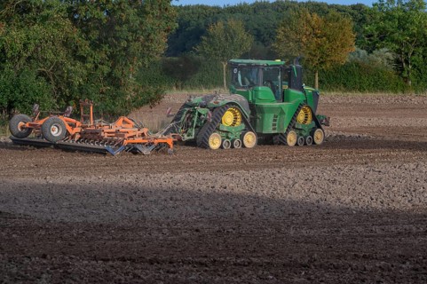 Crawler tractors harrow the field, Othenstorf, Mecklenburg-Western Pomerania, Germany