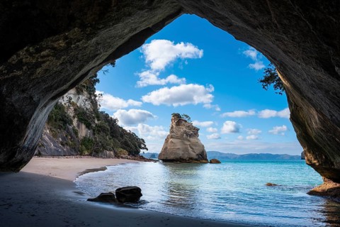 Cathedral Cove in New Zealand. Sea, sandy beach and limestone cliffs. The cave itself overlooks Te