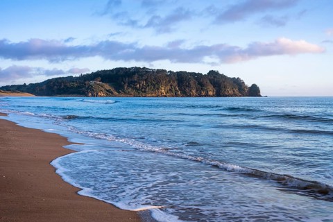 Landscape with sea and sandy beach in New Zealand. Hot Water Beach, Coromandel Peninsula, Waikato,