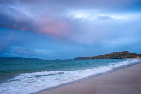 Landscape with sea and sandy beach in New Zealand in the evening at sunset. Otama Beach, Coromandel