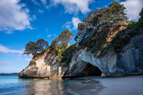 Cathedral Cove in New Zealand with ocean, sandy beach and limestone cliffs. Cathedral Cove, Hahei,