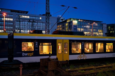 Incoming train, regional express, RE, bwegt, with bicycle compartment, in the background BW Bank,