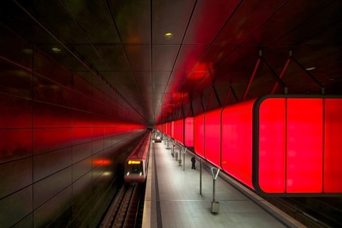 HafenCity University subway station, illuminated in color, red, underground train, movement effect,