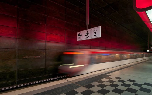 HafenCity University underground station, illuminated in color, red, underground train, movement