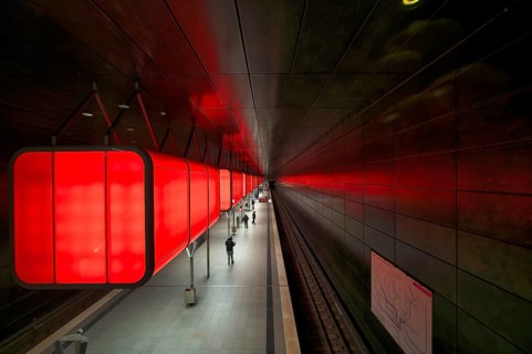 HafenCity University subway station, illuminated in color, red, travelers, platform, stop, train