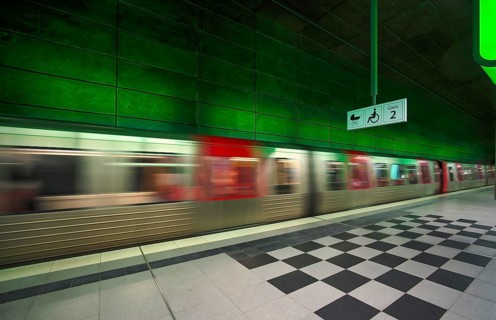 HafenCity University underground station, illuminated in color, green, underground train, movement