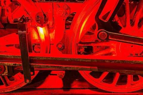Illuminated wheelwork of a historic locomotive, railway museum, Augsburg railway park,