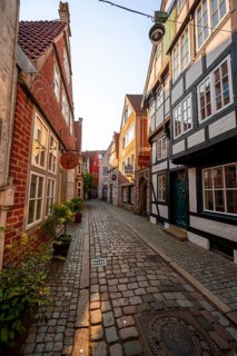 Colourful houses with shops and half-timbered houses in a small alley, picturesque district with