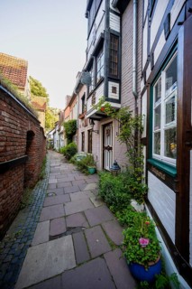 Colourful houses with shops and half-timbered houses in a small alley, picturesque district with