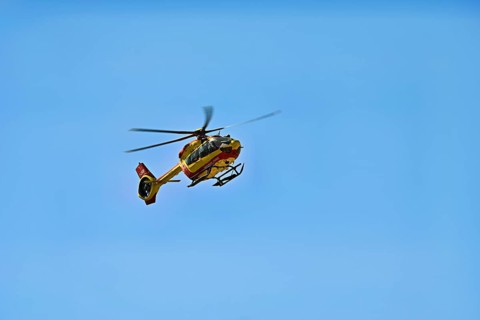 Helicopter flying against a blue sky, alpine rescue, mountain rescue, Chamonix, Haute-Savoie,