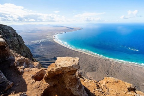 View from the Risco de Famara Cliff to Famara Beach, Playa de Famara with La Calaeta, Lanzarote,